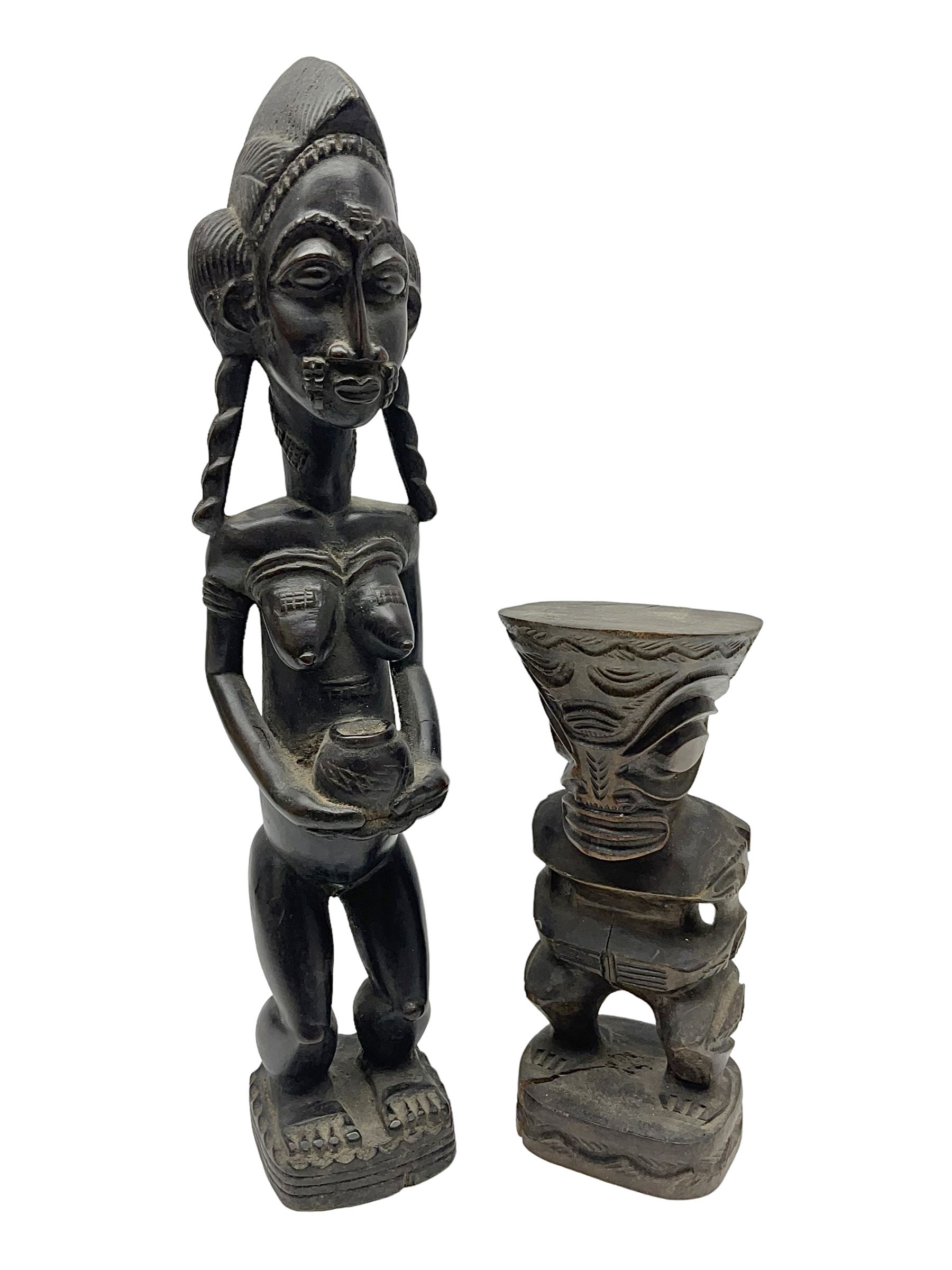 Carved african figures, together with a polynesian figure, largest H38cm