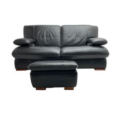 Two seat sofa, upholstered in black leather with white stitching, with matching footstool