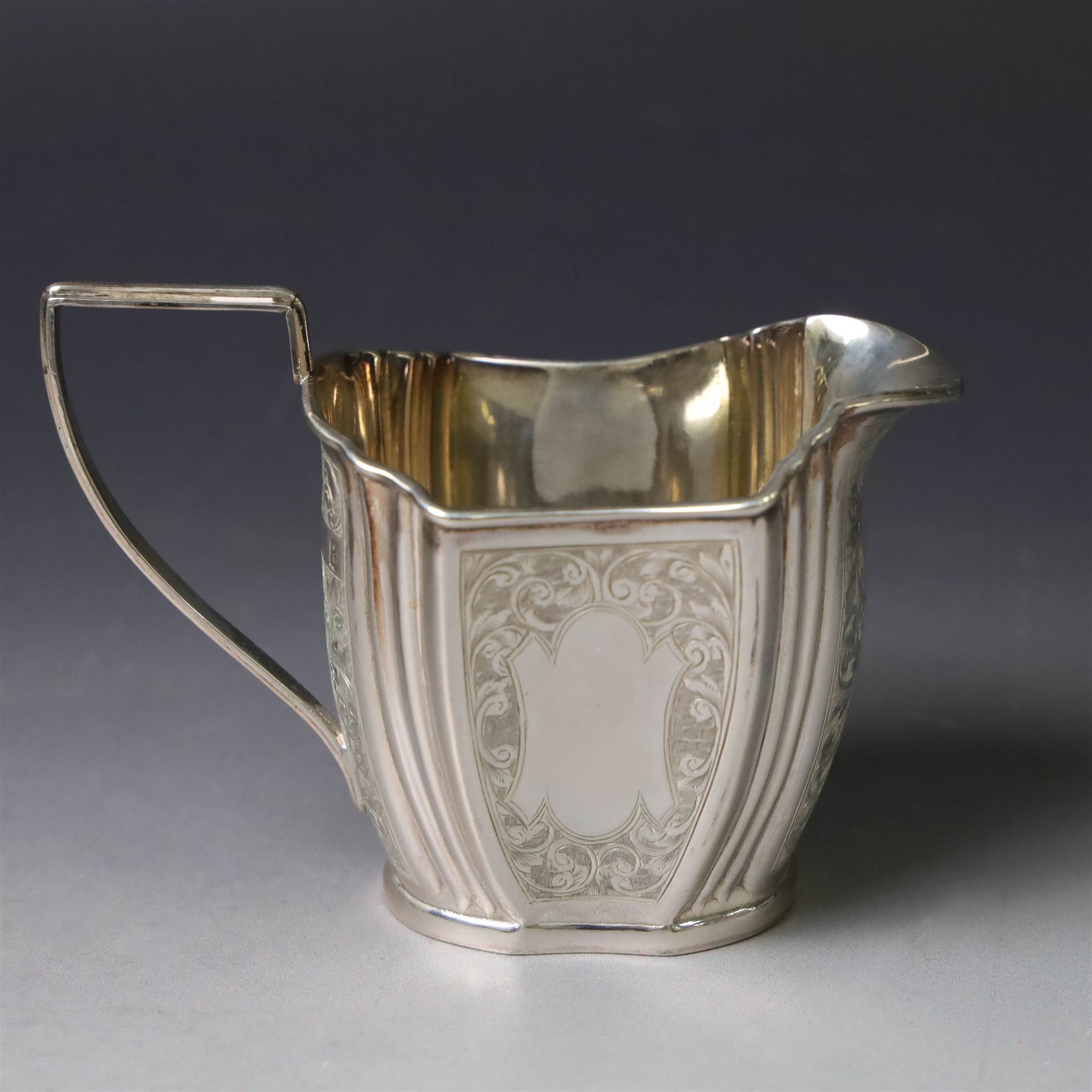 Late Victorian silver twin handled open sucrier and milk jug, of fluted form with panels of engraved foliate decoration, hallmarked D & M Davis, London 1896