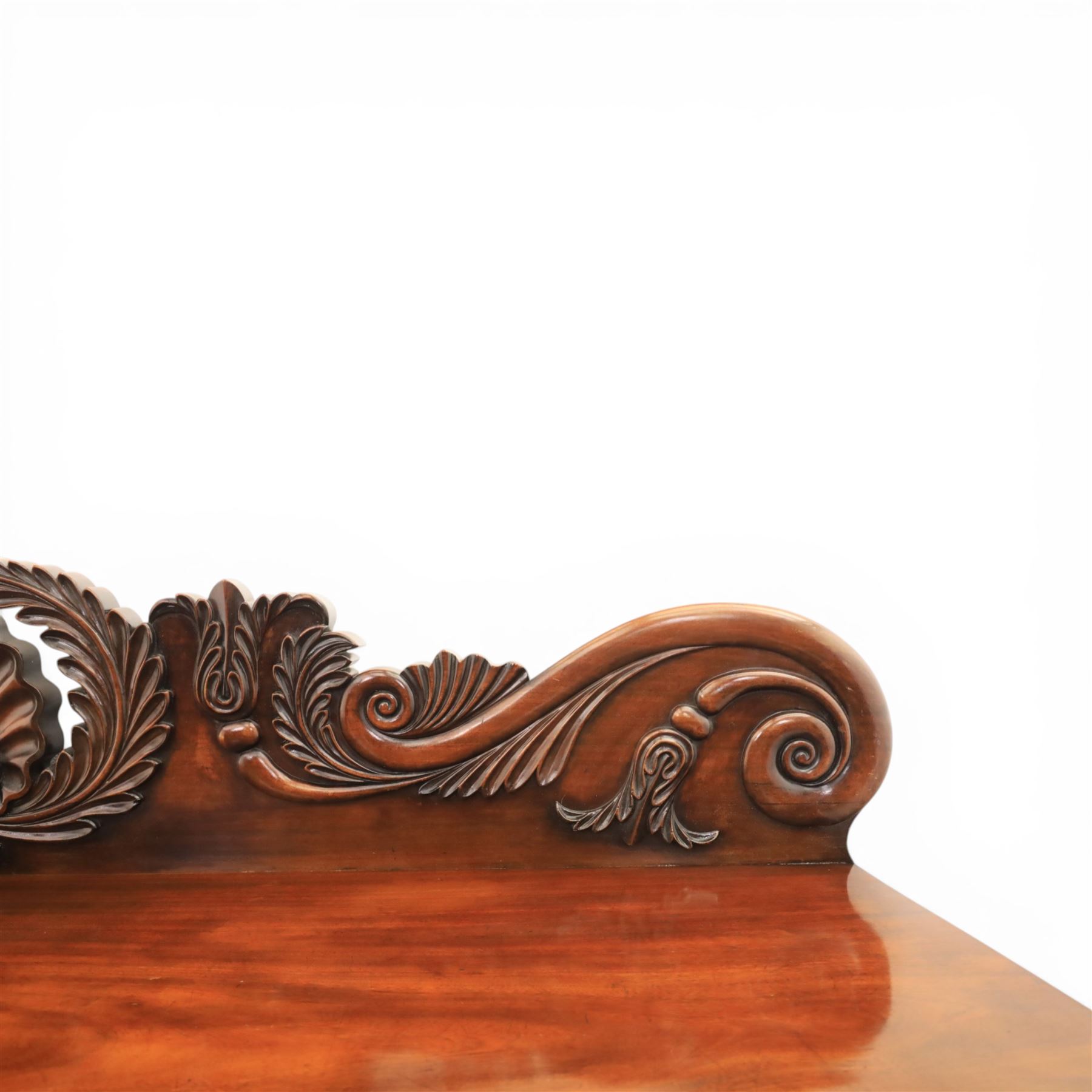 Mid Victorian mahogany pedestal sideboard, the rectangular top with raised back centred by a carved shell within scrolling acanthus and foliate cresting, over a central shaped frieze drawer flanked by two short drawers, above a kneehole recess, flanked by panelled cupboard doors with carved corbel supports, enclosing shelved interiors