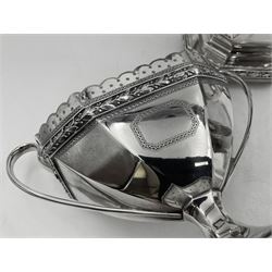 Victorian silver four piece tea service, comprising teapot, teapot stand, twin handled open sucrier and milk jug, each of octagonal form with foliate bud border and engraved decoration including crest to canted panels, and vacant panels, the teapot with ivory finial to the hinged cover and later wooden handle, hallmarked Edward Barnard & Sons Ltd, London1896, teapot including finial H15cm, milk jug including handle H16cm, teapot stand W11.5cm

This item has been registered for sale under Section 10 of the APHA Ivory Act