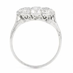 Early 20th century platinum diamond daisy flower head cluster ring, principal round cut diamond of approx 0.65 carat, surrounded by eight milgrain set old cut diamonds, within a pierced scroll design gallery, total diamond weight approx 2.15 carat