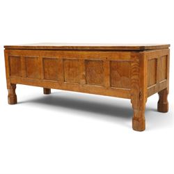 Mouseman - 1950s adzed oak blanket chest of unusual proportions, the rectangular hinged top with canted corners, over a sextuple panelled front, raised on turned octagonal feet, carved with mouse signature, by the workshop of Robert Thompson of Kilburn
