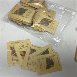 Quantity of Kensitas silk cigarette cards depicting world flags, together with albums of fish cigarette cards and quantity of crowns to include boxed examples