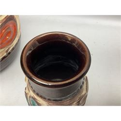 Pair of Bay West German vases, with bold moulded flower and foliage decoration in green, orange and ochre on brown ground, largest H40cm