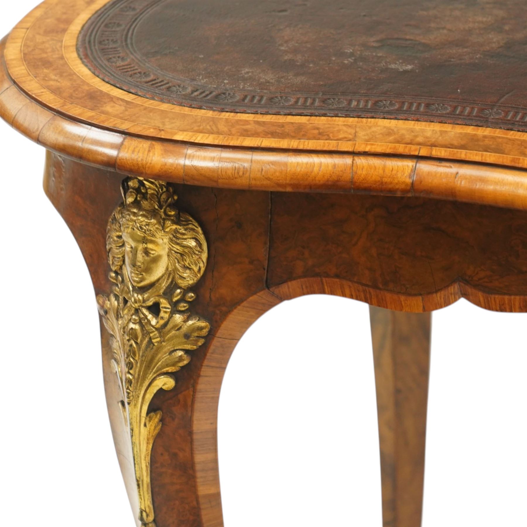 Gillow & Company (1862-1897) - Victorian figured walnut kidney shaped writing table, the shaped top inset with oxblood leather writing surface with embossed edge, surrounded by banded burr-walnut and crossbanding with moulded edge, fitted with single shaped frieze drawer flanked by scalloped side-aprons, raised on tapering and chamfered cabriole supports embellished with ormolu mounts in the forms of maidens over tapering acanthus leaves, the mounts trailing down the front of the legs to terminate to ormolu scroll feet, stamped 'Gillow & Co 3576' to drawer interior