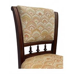 Victorian mahogany centre table, circular top above turned pedestal, terminating on three cabriole legs with scroll feet on porcelain castors, and six scroll carved upholstered dining chairs, with cushion and spindle turned backs, centre table  118x74cm, dining chairs 89x46x50cm