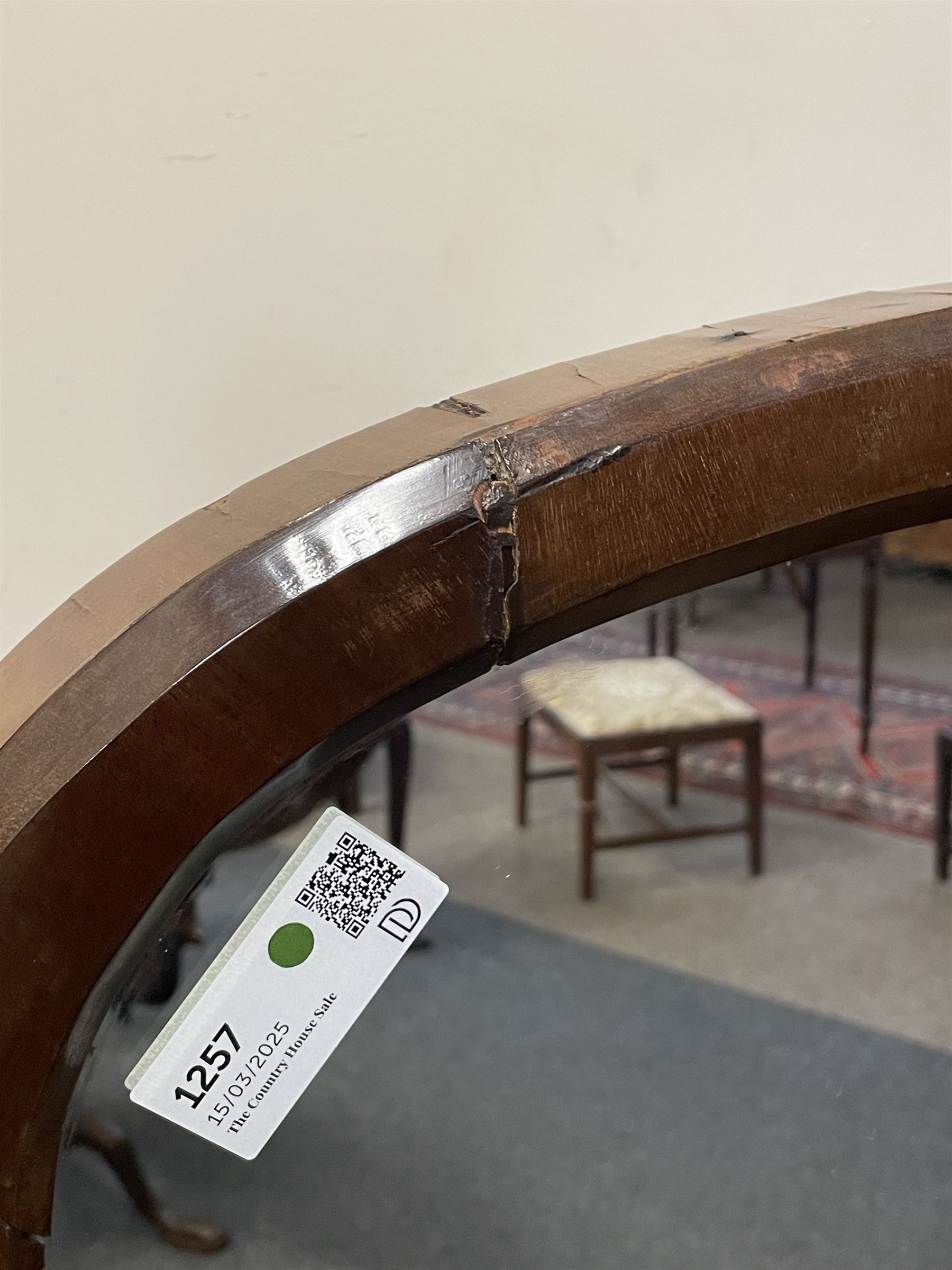 Early 19th century mahogany cheval dressing mirror, plain mirror plate within chamfered frame with arched top, on rolled horns and out-splayed rolled feet, united by turned stretcher 