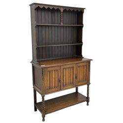  Early to mid-20th century oak dresser, raised two tier plate tack over two linenfold panelled doors, on spiral turned supports united by undertier 