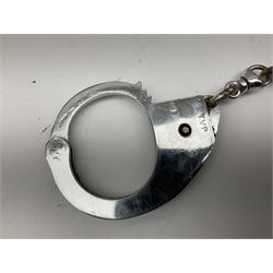 British Transport Police Custodian helmet with Queen's Crown plate; Hiatt & Co ebonised hardwood patrol truncheon; and pair of Hiatts 1960 hand-cuffs (3)