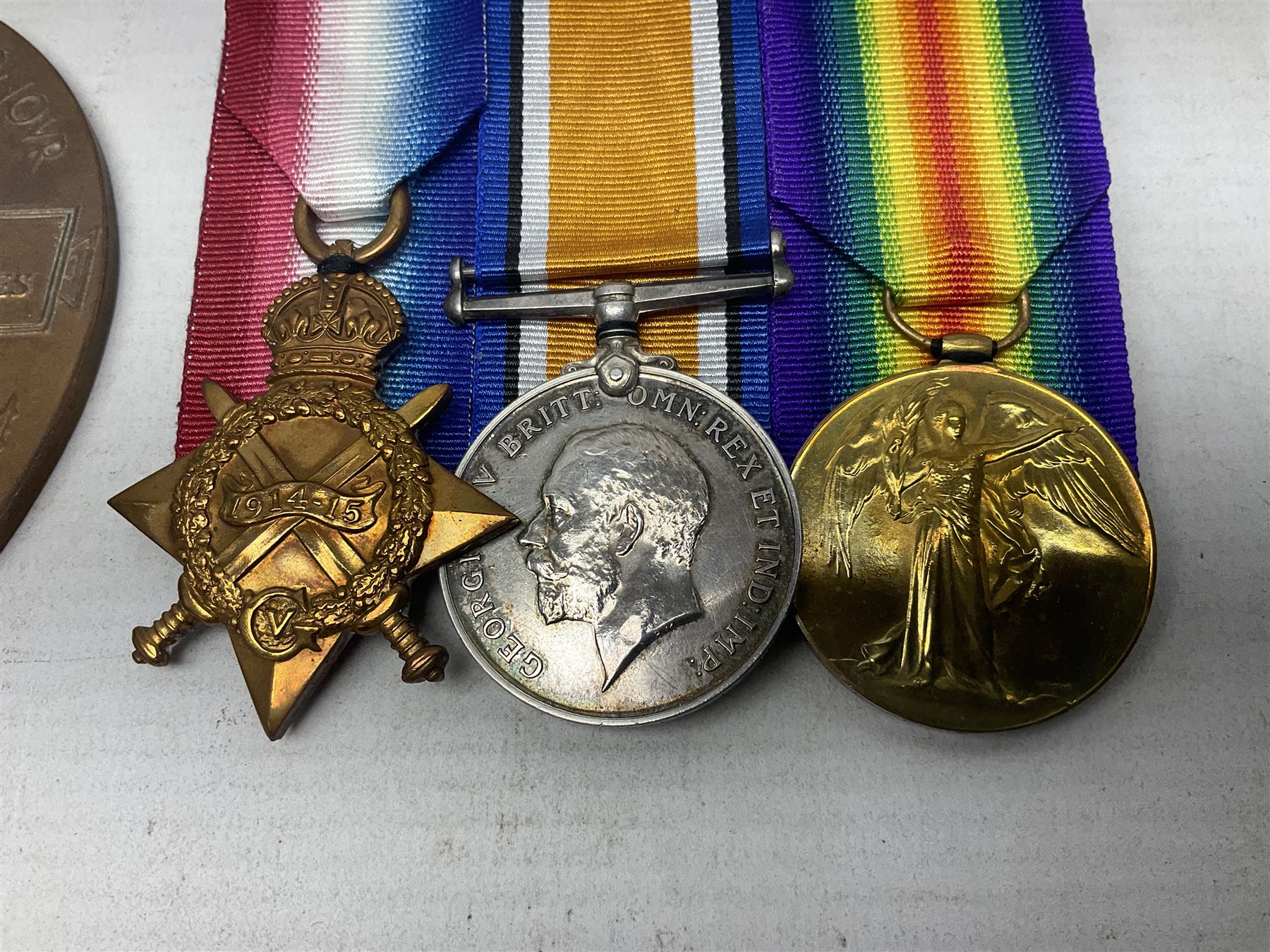 WW1 KIA group of three medals comprising British War Medal, 1914-15 Star and Victory Medal together with bronze Memorial Plaque named to G-13 Pte. F.G. Hodges R. Suss. R.; with ribbons; displayed on modern board for wearing; some biographical details