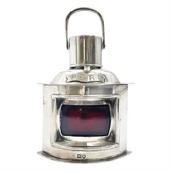  Early 20th century silver novelty inkwell, modelled as a ship's port lantern, with swing handle, convex red glass panel and hinged cover opening to reveal a glass liner, hallmarked Samuel Jacob, London 1911, height not including handle H8.5cm