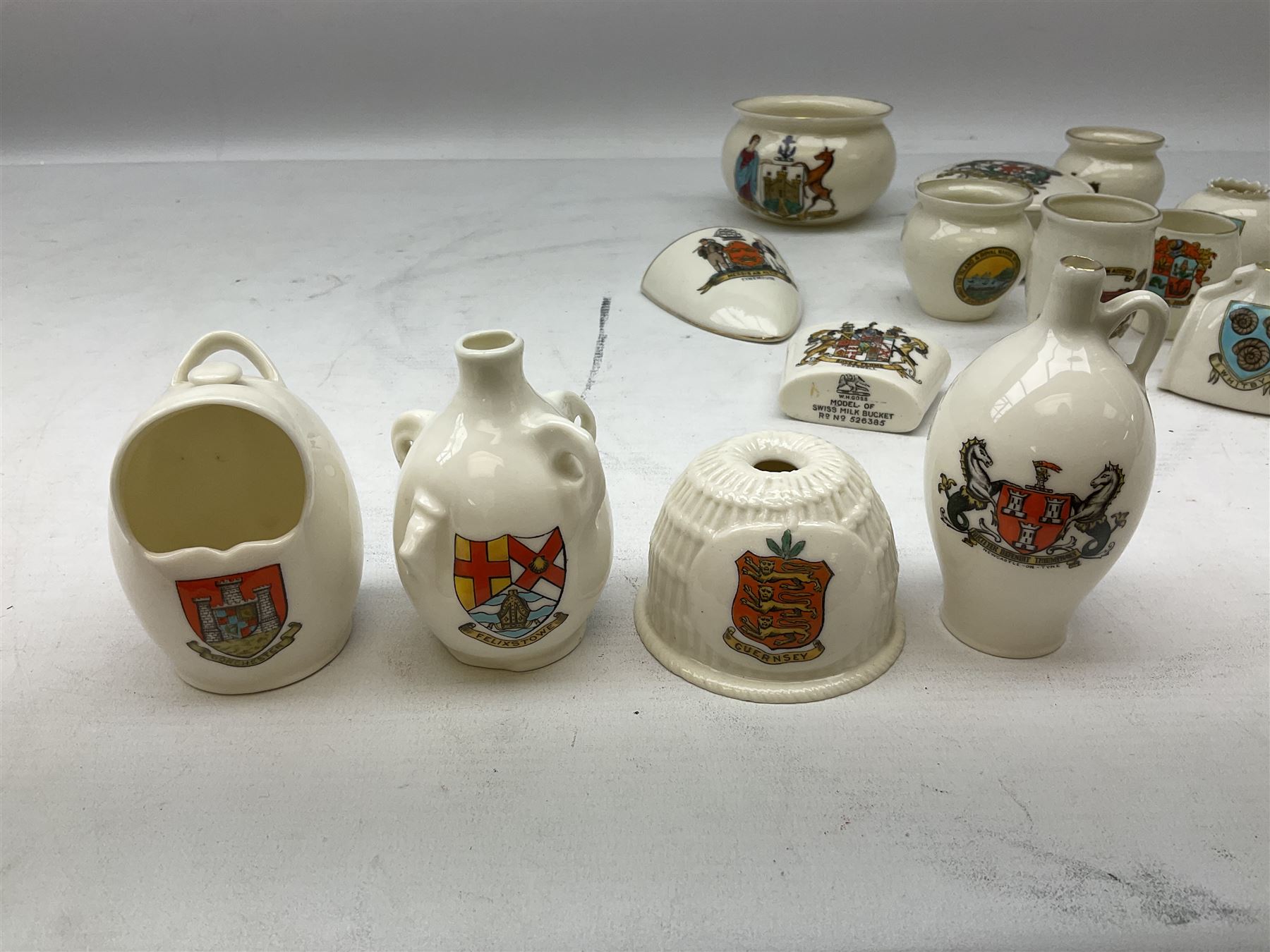 W H Goss crested china to include Guernsey lobster trap, Newcastle-on-Tyne wine flagon, Felixstowe water bottle, Dorchester salt pot etc