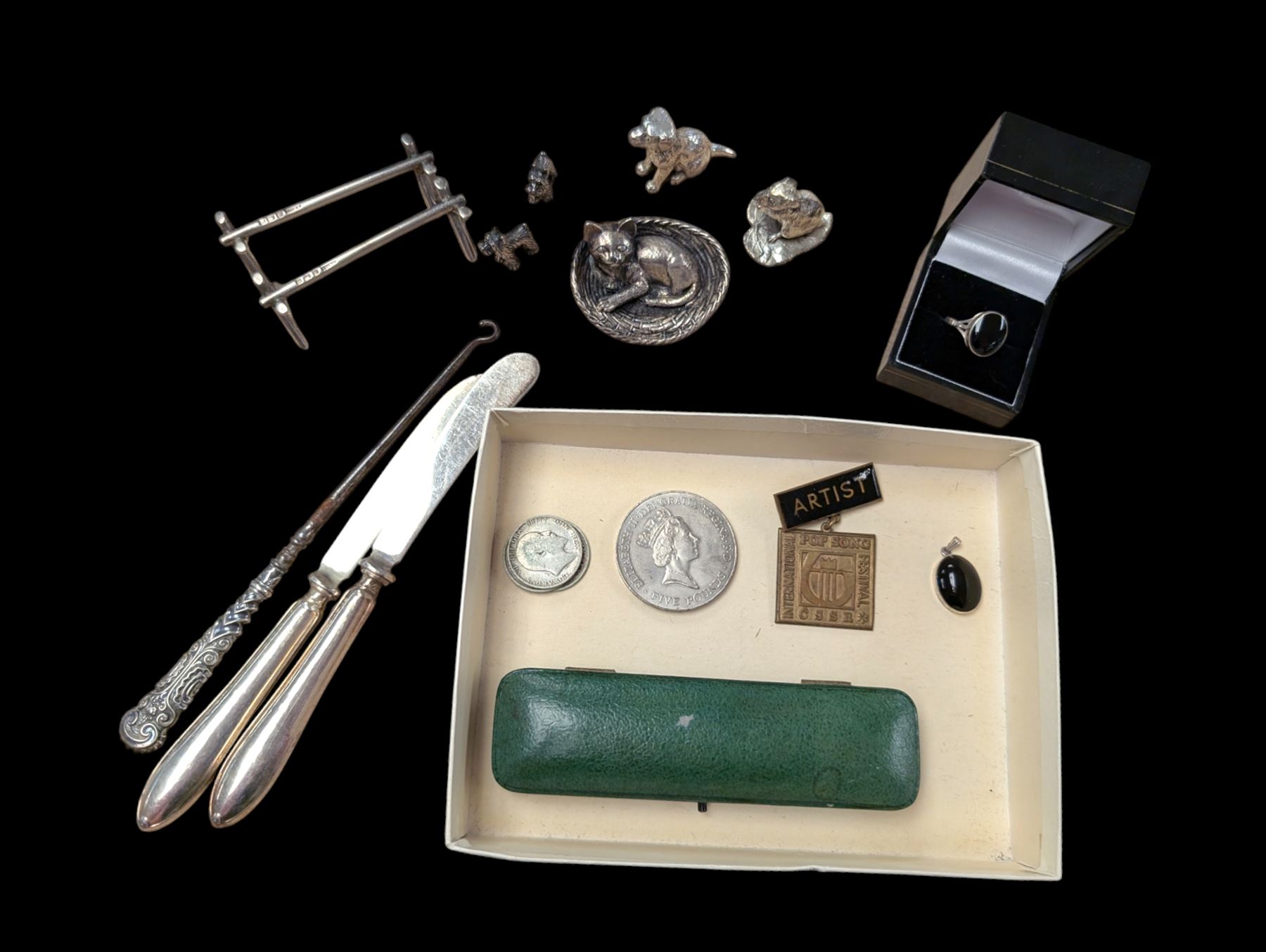 Pair of silver knife rests, two silver handled butter knives and a silver handled button hook, all hallmarked, together with a silver onyx pendant and ring, white metal figures and coins etc 