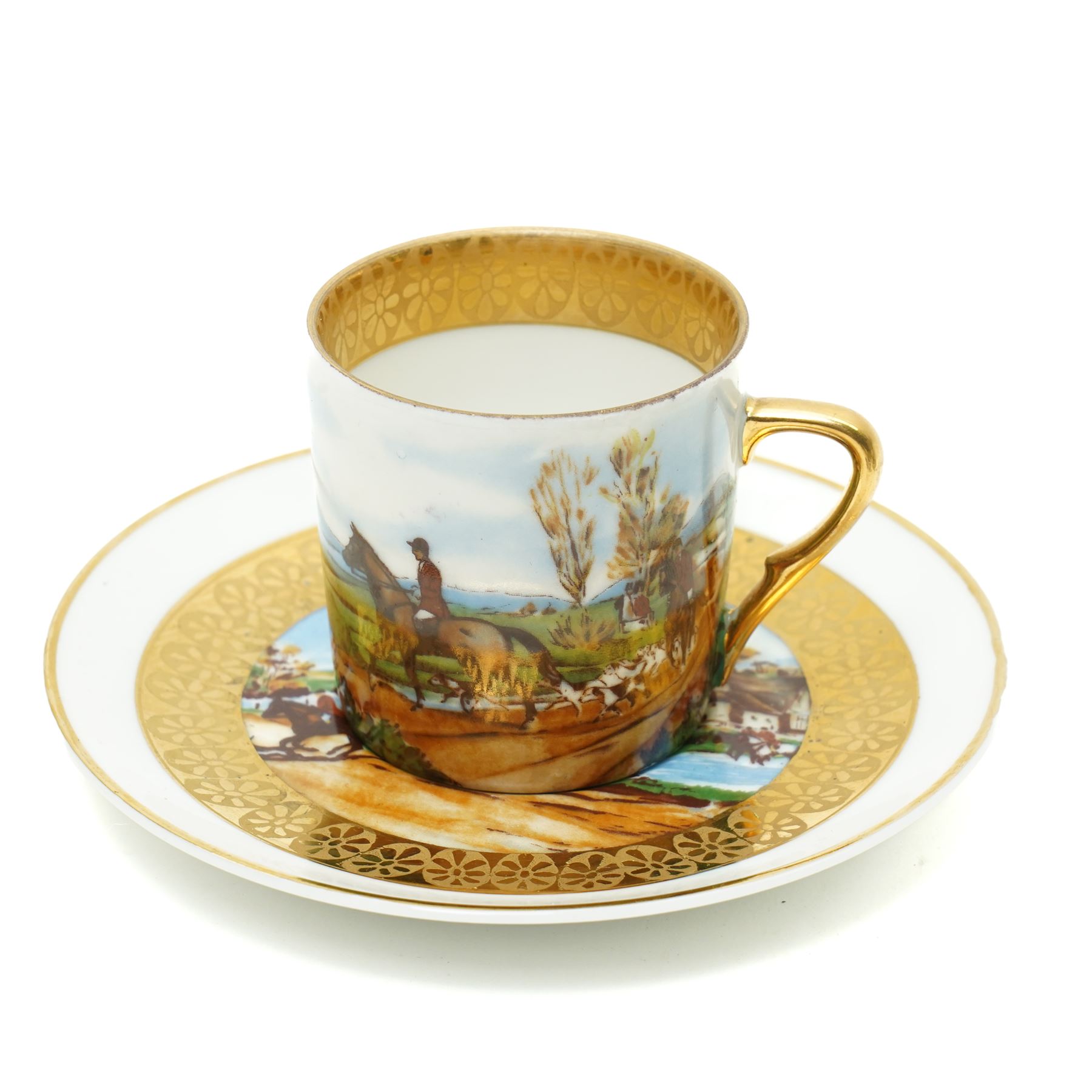 Limoges  coffee set decorated with hunting scenes within a gilt border comprising twelve cups and saucers, coffee pot, cream jug and sugar bowl