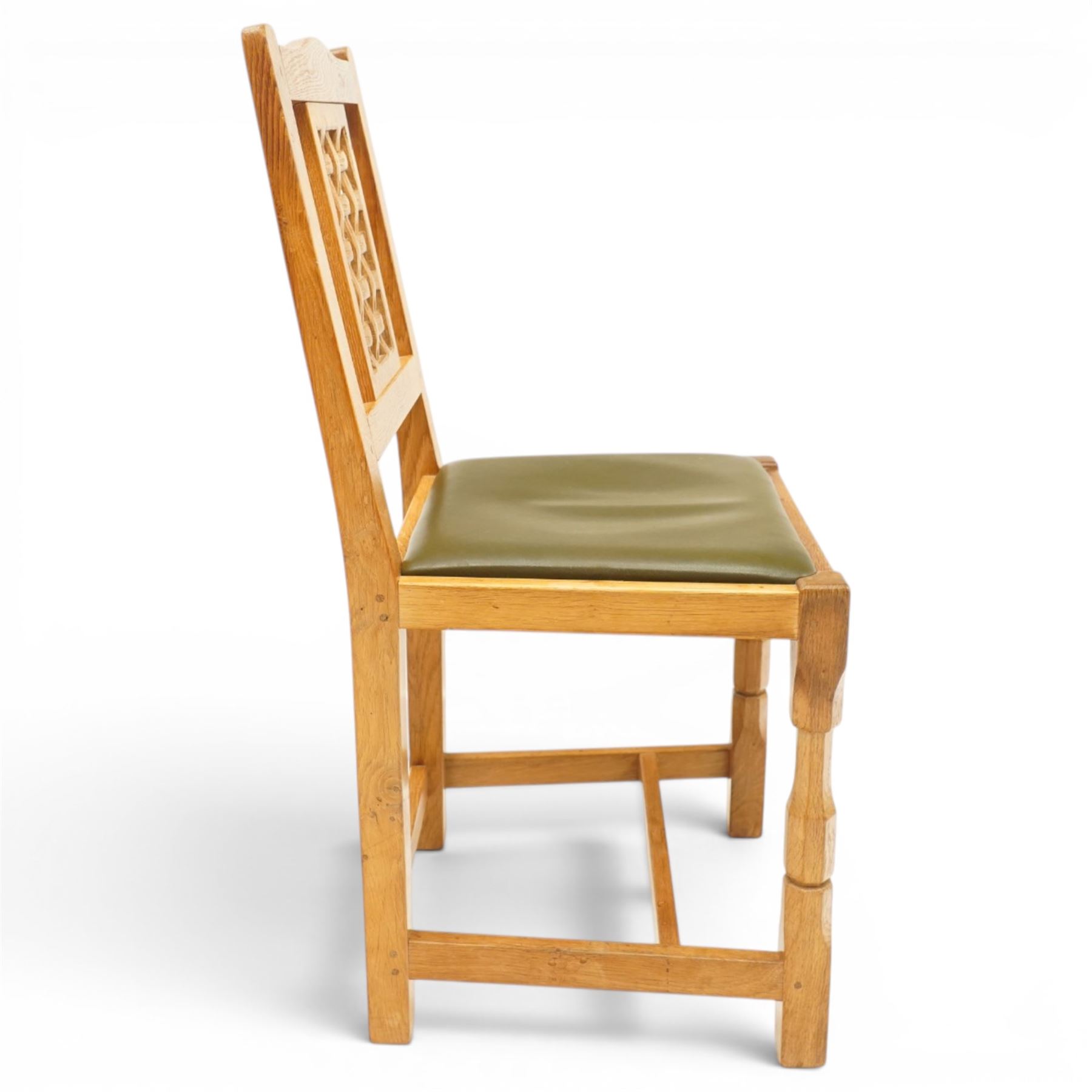 Beaverman - 1980s set of four lattice back dining chairs, shaped top rail above a lattice back, green leather fixed seat, raised on octagonal front supports, with carved Beaver to the back stretcher, by Colin Almack of Sutton near Thirsk
