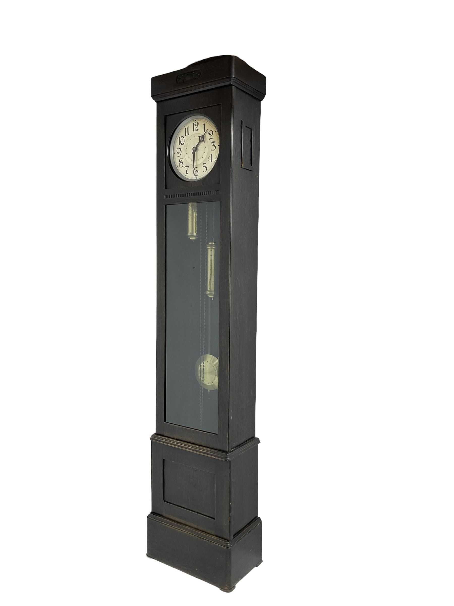 20th century Art Deco- oak cased 8-day longcase clock c1930, flat topped case with a fully glazed door on a stepped plinth, silvered circular dial with Arabic numerals and pierced steel hands, chain driven twin train movement with  4 gong rods. With pendulum and two brass cased weights.