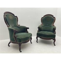 Pair of Victorian rosewood drawing room armchairs, shaped and moulded frames carved with scrolls, the arms with scrolled terminals and shaped foliate carved supports, upholstered in green velvet, serpentine sprung seats, the cabriole supports carved with flower heads terminating at castors