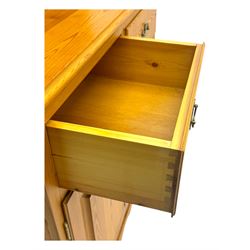 Victorian design pine dresser, projecting moulded cornice over scalloped frieze and two open shelves, base fitted with two drawers over double cupboard, on shaped plinth base