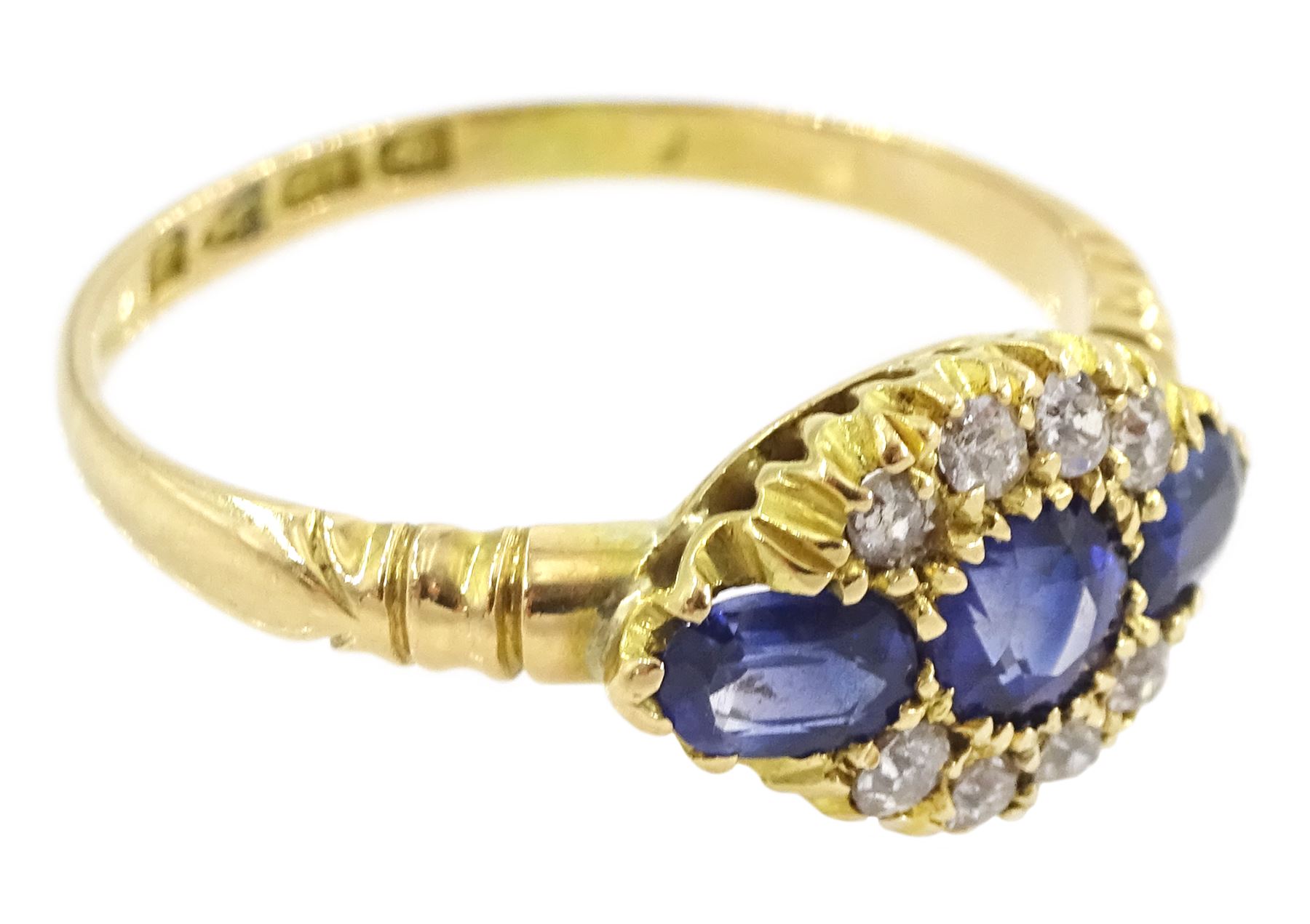 Early 20th century 18ct gold three stone oval cut sapphire and eight stone diamond cluster ring, Chester 1916