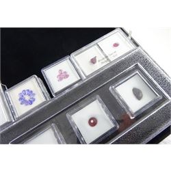 Collection of loose gemstones including tanzanite, fluorite, rubellite, opal, tourmaline, rhodolite garnet, emerald, ruby and amethyst, some with certificates