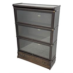 Globe Wernicke - early 20th century oak three-tier stacking library bookcase, three glazed sections enclosed by hinged and sliding doors, raised above a single lower drawer with metal drop handles