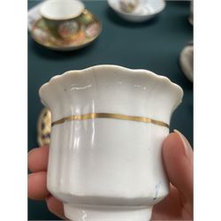 19th century teacup and saucer, possibly Coalport, decorated with panels of flowers on a cobalt blue ground with gilt decoration; together with two other teacup and saucer pairs, one with hand painted landscape decoration 