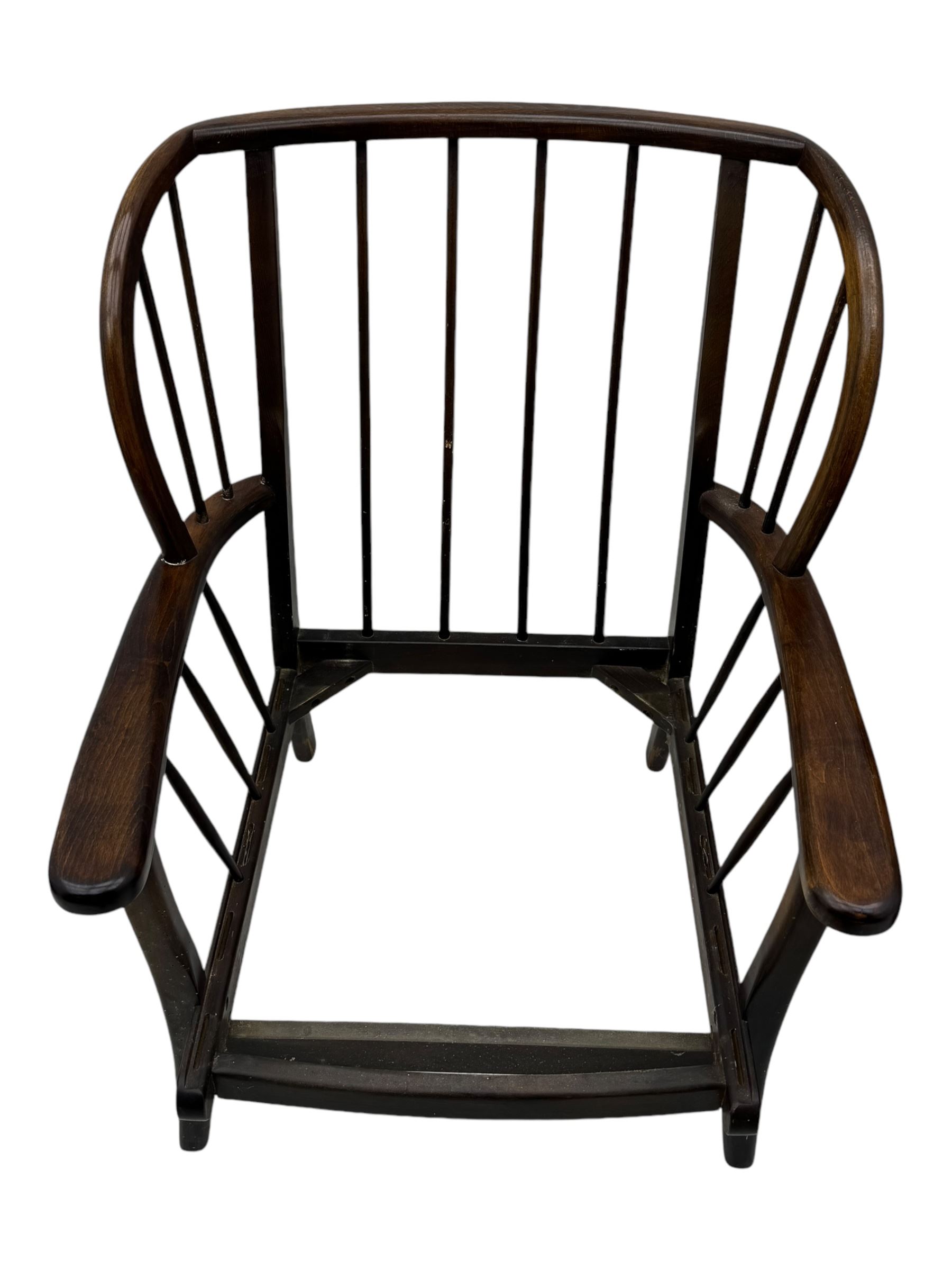 Joynson Holland - pair of mid-20th century stained beech framed easy chairs, shaped back and flat armrests over floral tapestry cushioned seat and back, on splayed supports united by stretcher