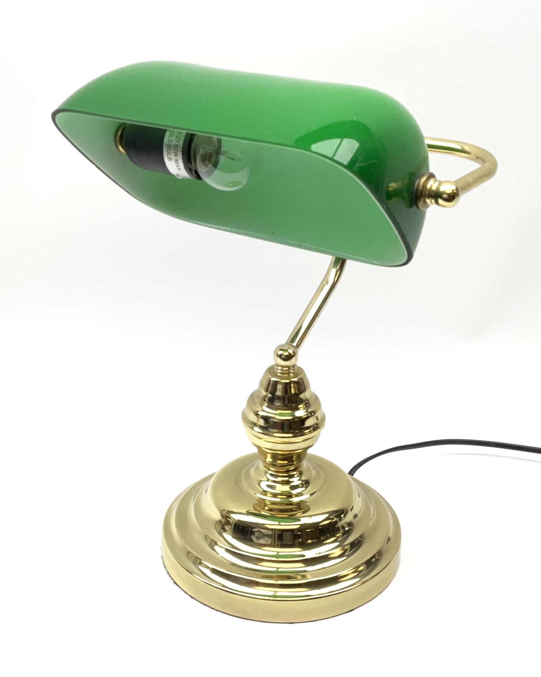 A brass bankers desk lamp, with adjustable green glass shade and
