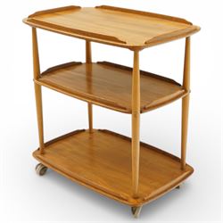 Ercol - elm tea trolley, Model 458. Rectangular three-tier form with shaped gallery edges,...