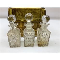 19th century brass repoussé perfume box, the ornately decorated casket with hinged domed cover lifting to reveal gold velvet lined interior containing three glass scent bottles, H14cm W15cm D7cm