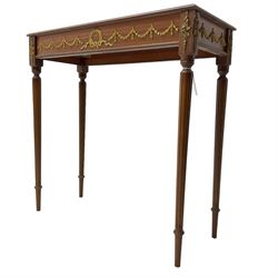 Early 20th century mahogany side table, inset amber leather surface, frieze decorated with applied gilt festoons and central wreath, on tapering fluted supports