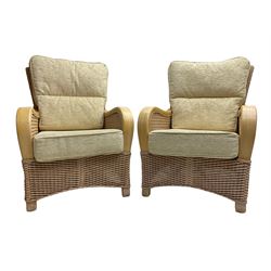 Contemporary rattan conservatory suite - two seat sofa with wicker frame and loose cushions upholstered in textured champagne fabric (W125cm H98cm); pair of matching armchairs (W72cm H98cm); rectangular glass-topped coffee table with rattan frame and undertier (W85cm D60cm H47cm); and matching square side table (W53cm H55cm)