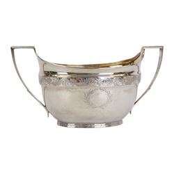 George III silver three piece tea service, comprising teapot with ivory scroll capped curved handle and ivory finial to the hinged cover, twin handled open sucrier with gilt interior, and cream jug with gilt interior, each of oval form with rounded sides, the bodies engraved with central monogram within a seaweed wreath, between engraved foliate bands, hallmarked John Emes, London 1801, teapot including handle H17cm

This item has been registered for sale under Section 10 of the APHA Ivory Act