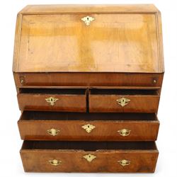 18th century walnut and herringbone banded bureau, the fall front enclosing a stepped and arched interior fitted with pigeonholes, drawers and concealed compartments, green tooled leather writing surface, over two short and three long graduated drawers with brass escutcheons and bail handles, shaped bracket feet