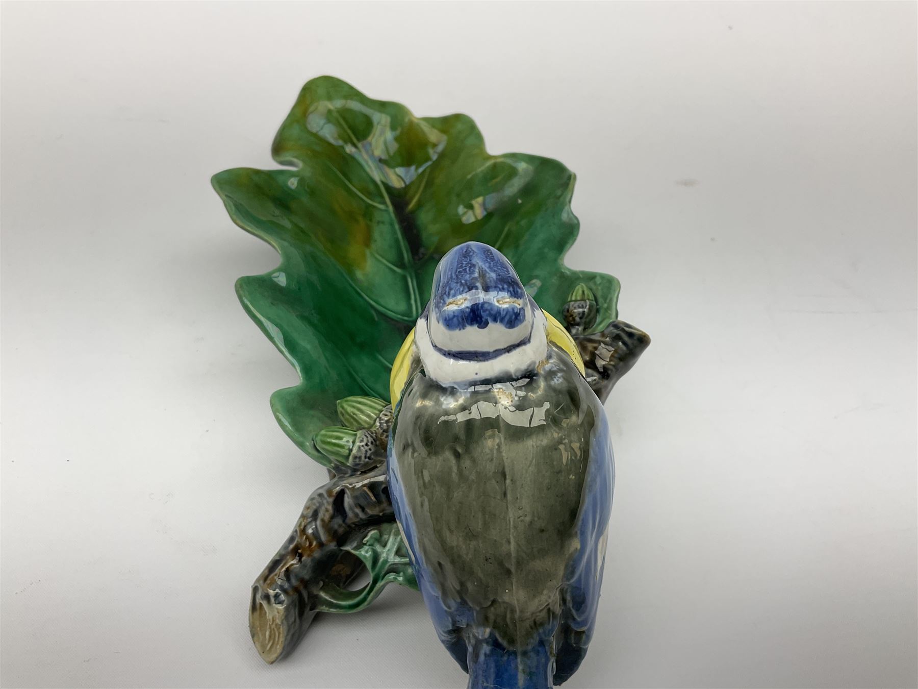 Minton majolica leaf dish, modelled as a Blue Tit perched on a branch with acorns and an oak leaf, date cypher for 1868, impressed marks beneath, L21cm. 