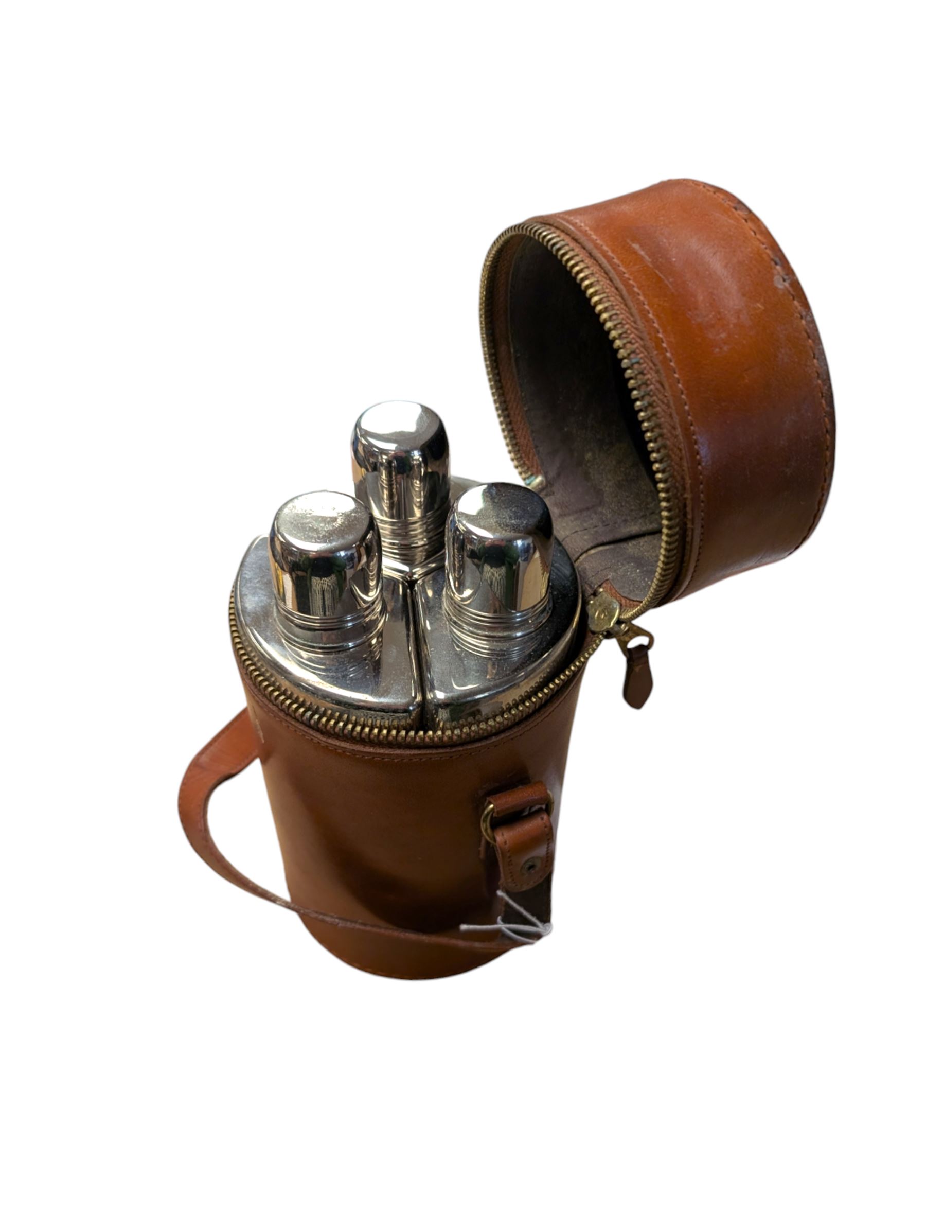 Set of three curved glass flasks with EPNS collars and lids, contained within a hide case with gilt initials