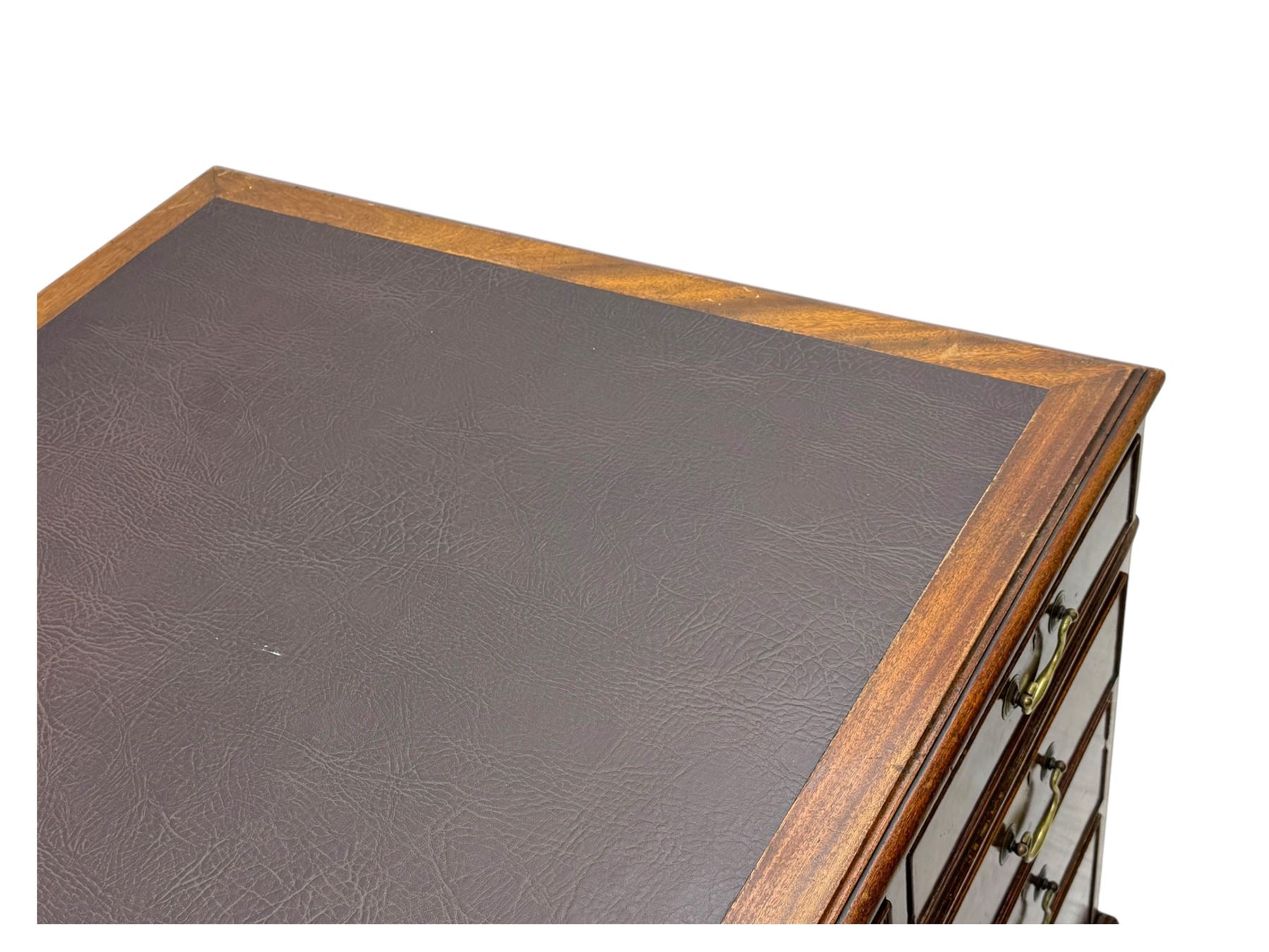 Edwardian mahogany twin pedestal desk, rectangular burgundy leather top moulded edge, over three short drawers with brass swan neck handles, over twin pedestals with graduating drawers supported on bracket feet