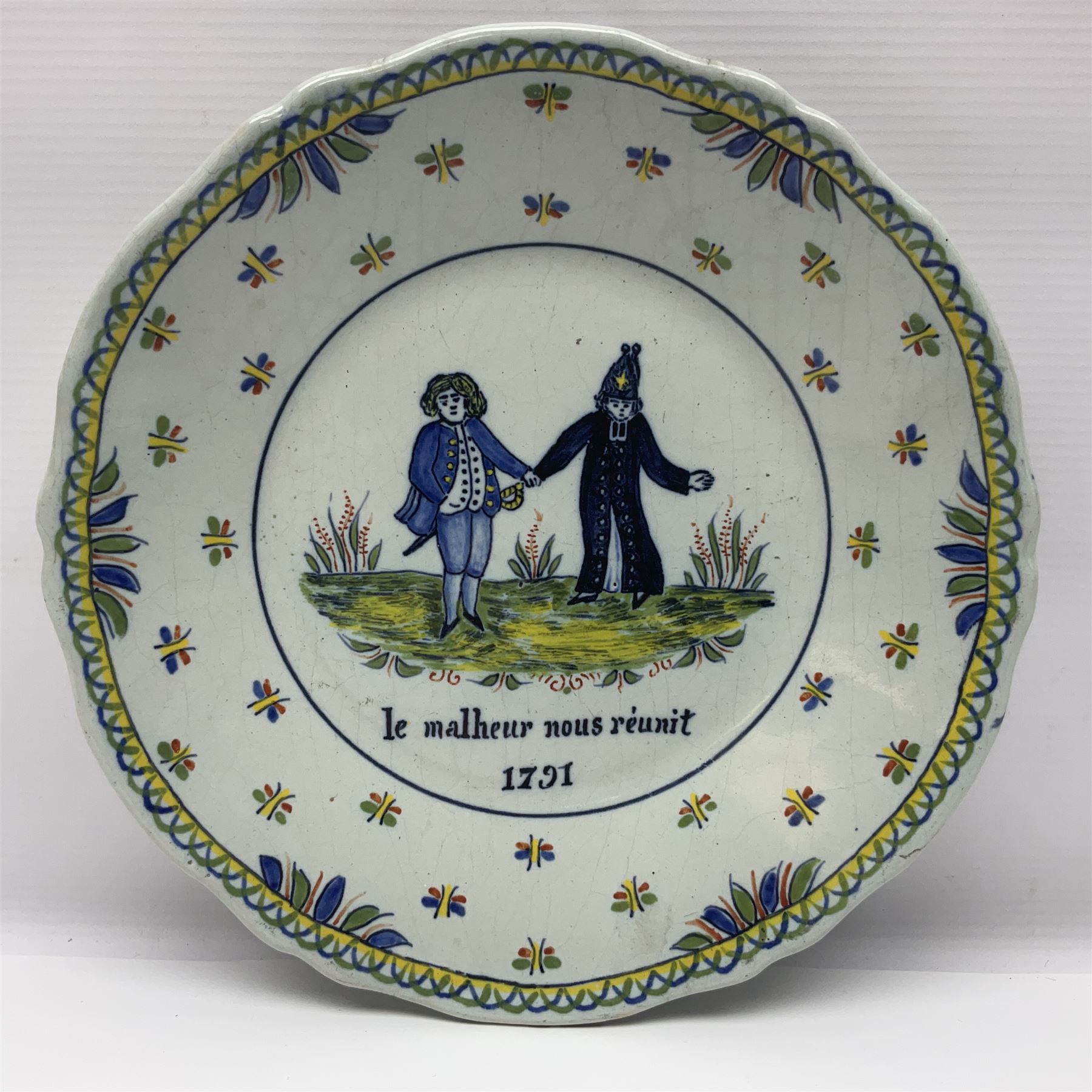 Four French Faience plates, comprising Je suis las de le porter, Le malheur nous reunit, Je desire y arriver and Eveque de Meaux, D24cm  