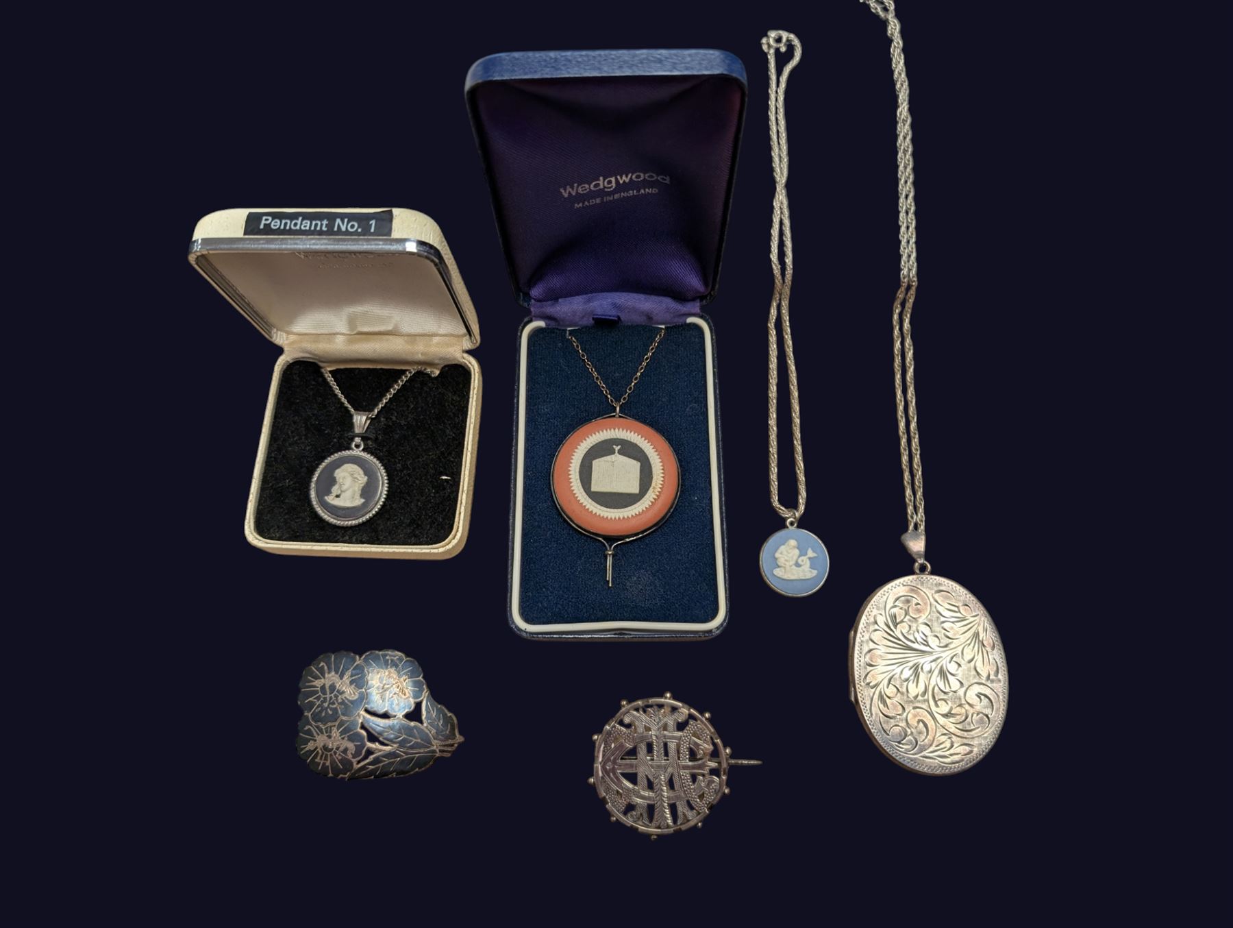 Three Wedgwood Jasperware pendant necklaces, a silver locket necklace and two silver brooches