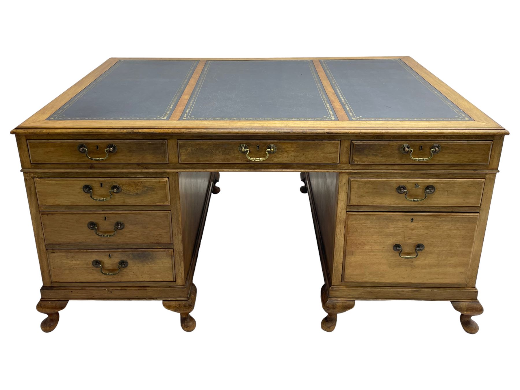 Early 20th century mahogany twin pedestal desk, the moulded rectangular top with three sectional leather insets with gilt decoration, fitted with eight drawers, on cabriole feet