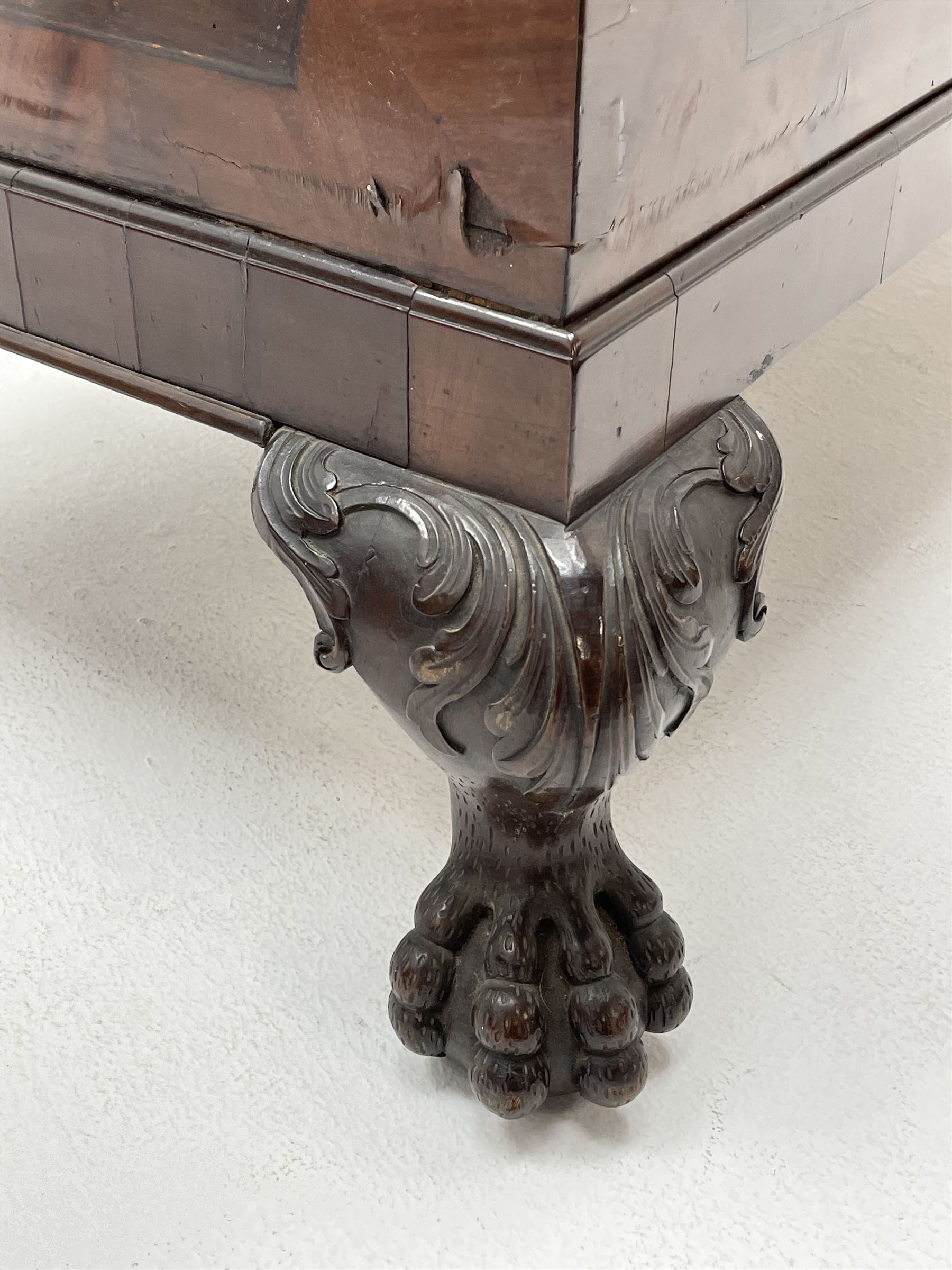 19th century camphor wood and mahogany silver chest, the hinged banded top with circular brass mounts which secure the interior strap hinges, fretwork metal strapping to the corners, on stand with plain frieze and acanthus carved cabriole ball and claw feet