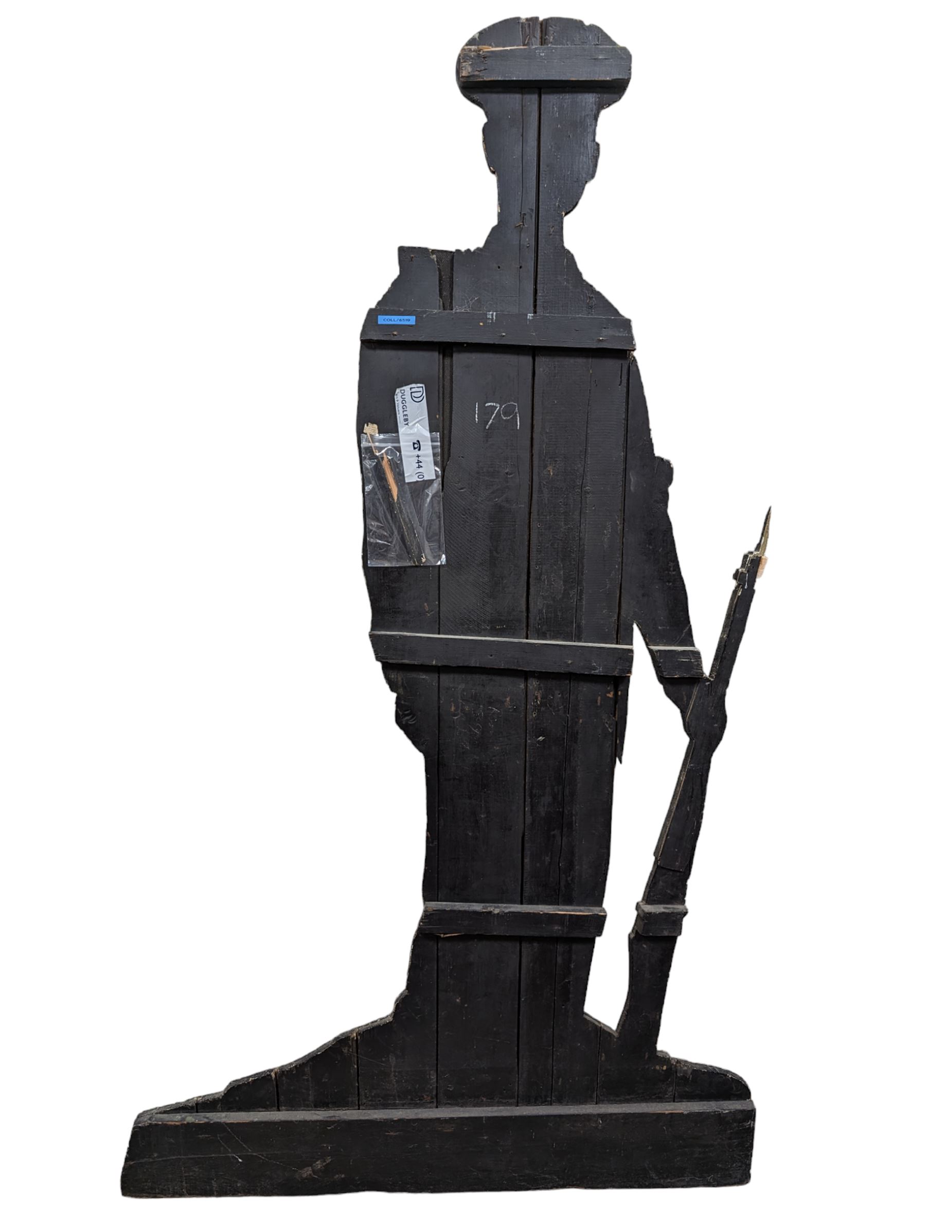 Military Outfitters hand painted life size wooden cut out figure of a WW1 soldier standing at ease holding a gun by his side, marked Stening Signs; hardboard on planked frame H199cm