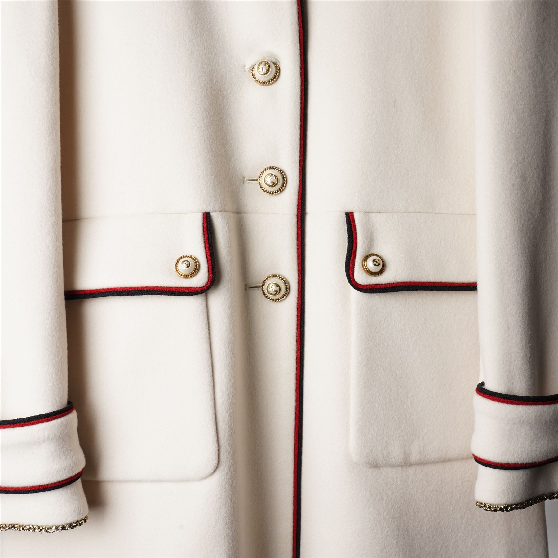 Gucci - bee embroidered wool single-breasted military coat, from the Autumn/Winter 2017 collection under Alessandro Michele, in ivory, with stand collar, red and navy trim, pearlescent and gold-tone button fastening and embroidered bee detailing to the collar, size 14, unused with original garment bag and tags