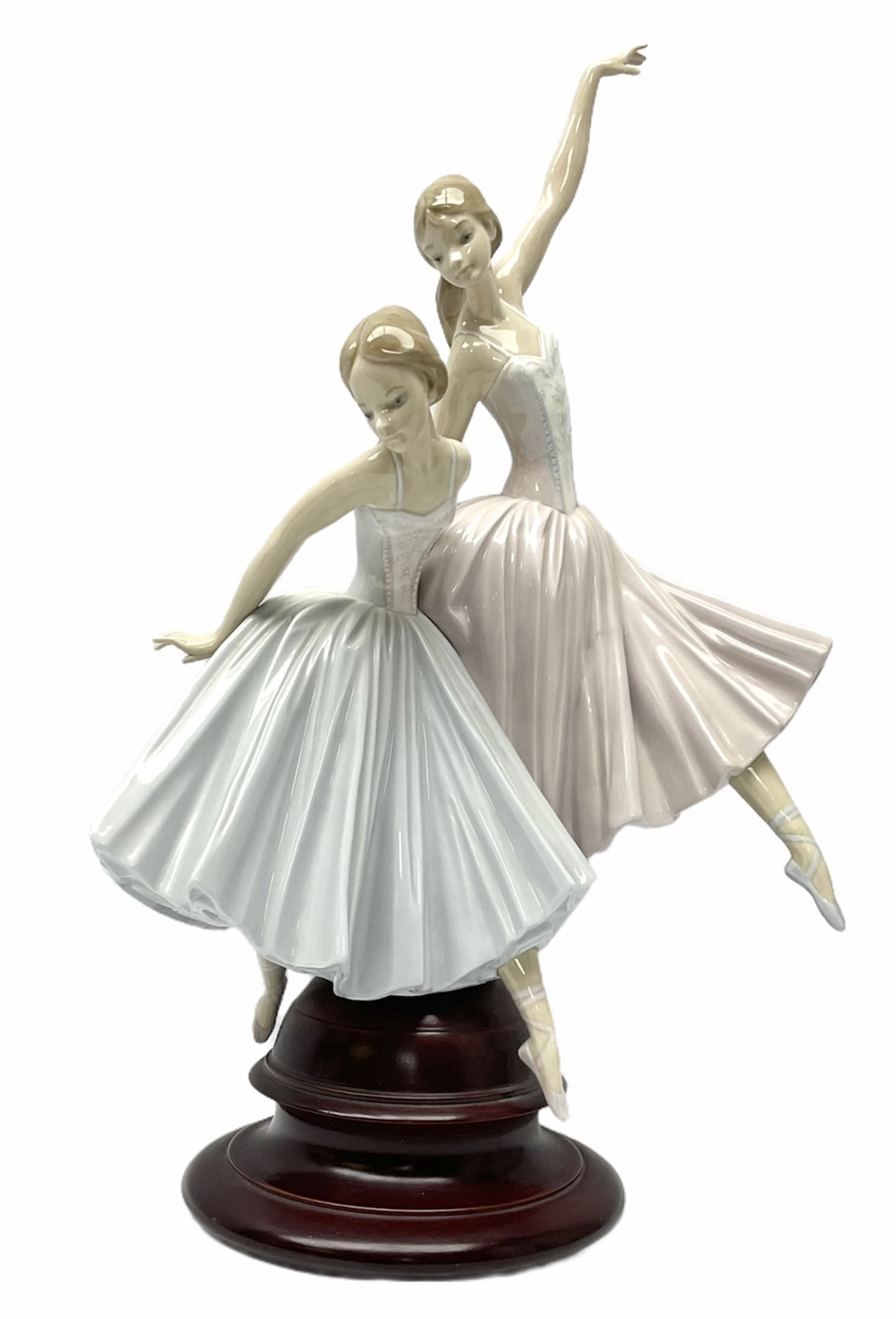 Lladro figure group, 'Merry Ballet', modelled as two ballerinas in dancing pose, raised on a turned socle base, no. 5035, printed marks beneath, H49cm