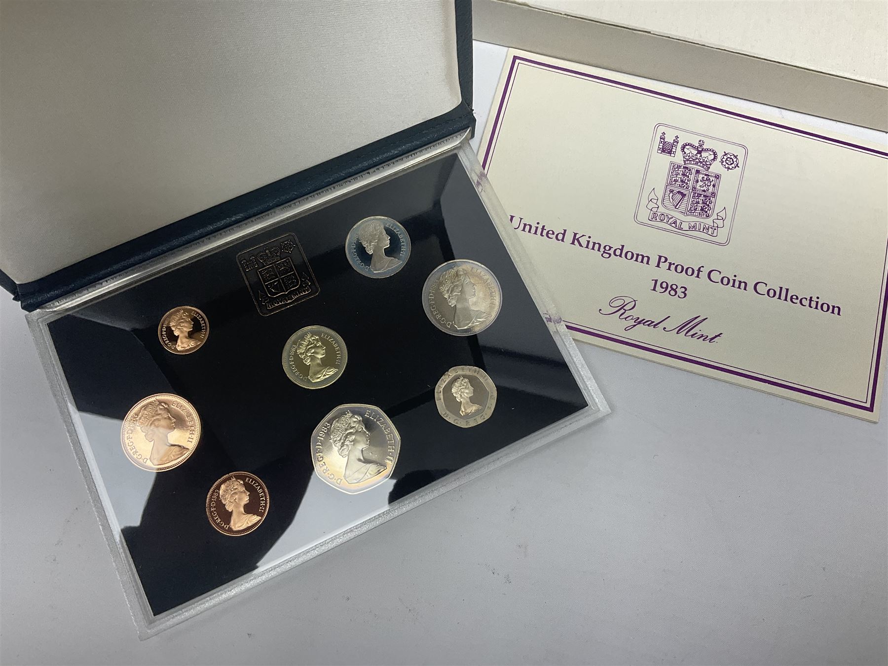 The Royal Mint United Kingdom 1983 proof coin collection in blue folder with certificate, 1983 uncirculated coin collection, two 1987 brilliant uncirculated coin collections, commemorative crowns etc