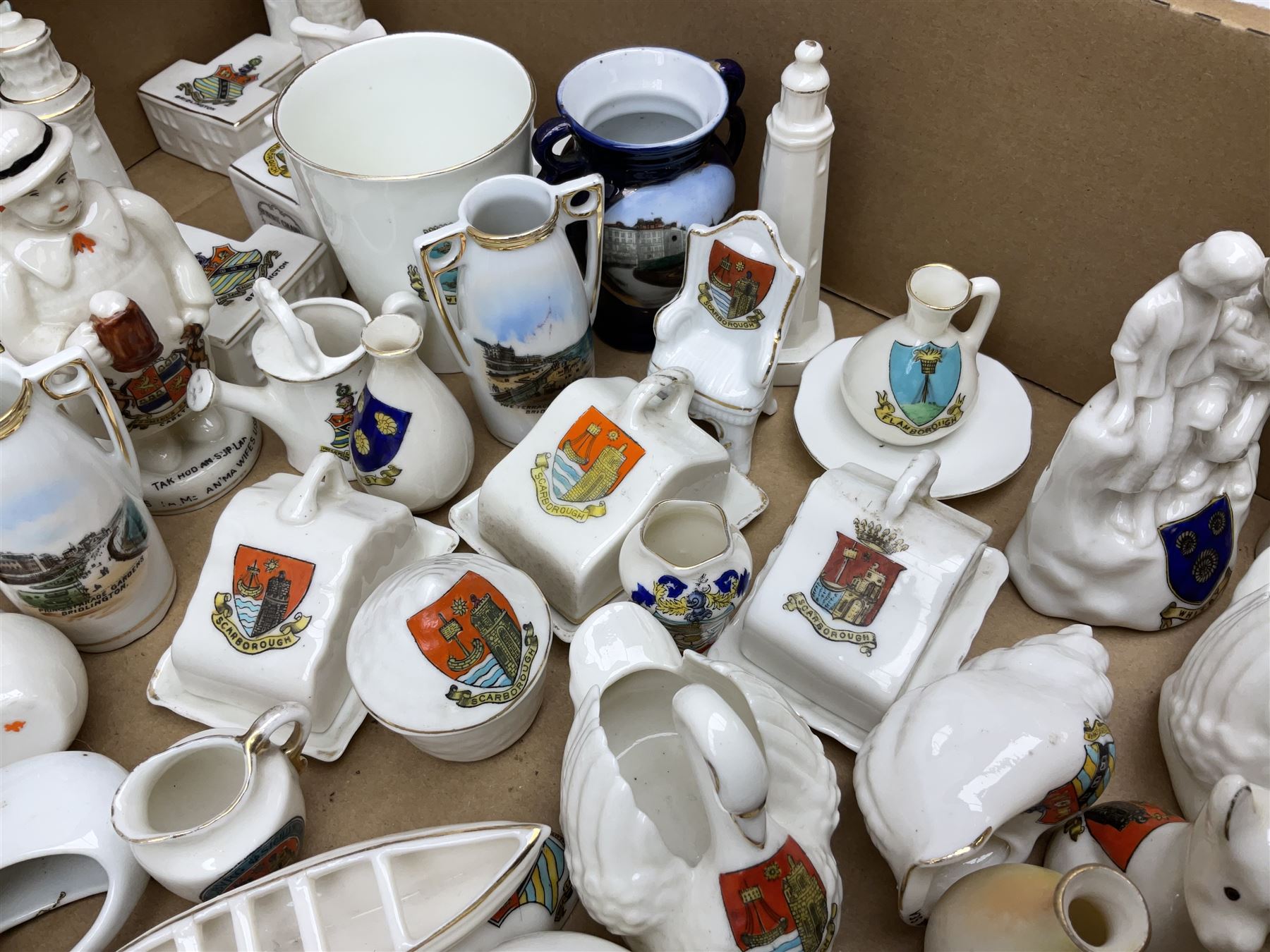 Collection of crested ware, to include Scarborough Willow Art coal truck, Whitby Willow Art Burns and Highland Mary figure group, Carlton China beer drinker 'Tak Hod an Sup Lad', and 'Here's ta me an'ma wife's usban', lighthouse, boat, Kingsway Art China Sir Walter Scott's Chair, butter dishes, candlestick, pianos etc