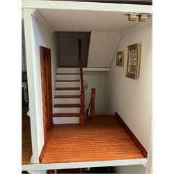 'The Hollies' - good quality sectional wooden doll's house in the form of a Georgian style four-storey bay windowed town house with simulated brick front elevation, rendered sides, off-set corner stonework, faux slate-hung top floor with flat roof and chimney stack, working sash windows, iron railings around front basement courtyard with hinged front elevation to two rooms with  spiral staircase, side hinged central section approached by external steps with iron balustrades to the sides leading to a front door, entrance hall with stairs to landing and two rooms on two floors with dado panelling and fire-surrounds, the top floor with top hung front elevation revealing stairs to a landing and bedroom; wired for electricity L51cm D65cm H107cm including chimney; together with a good quantity of quality wooden furniture and accessories including piano, dressers, bookcase and books, rugs, double half-tester bed, metalware, pictures etc