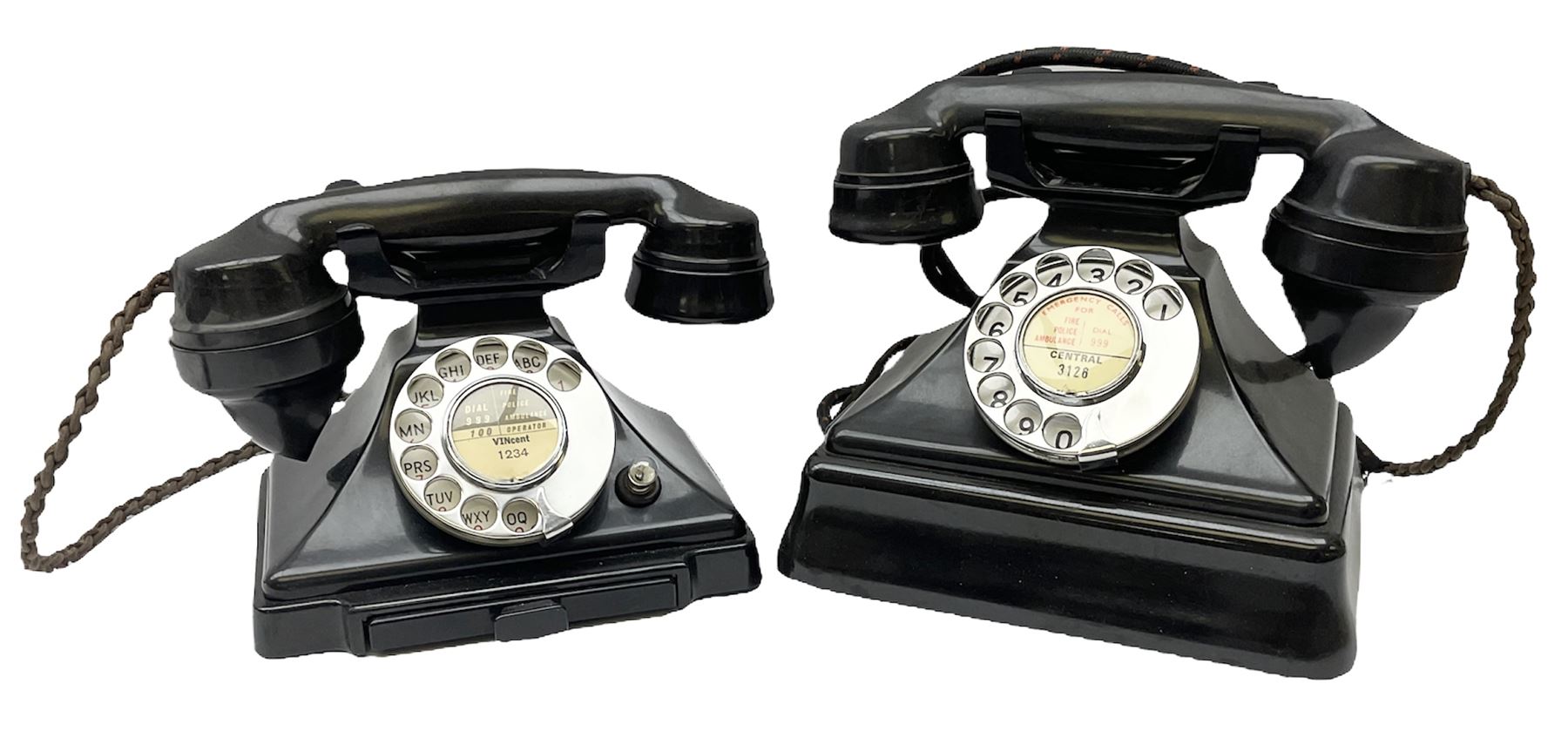 Two black Bakelite telephones of pyramid form with rotary dials, comprising The Telephone Demonstration Set model. 6al with base drawer and light bulb, and another larger with G.P.O FWR 58/2 stamped marks beneath, largest H18cm W20cm D16cm