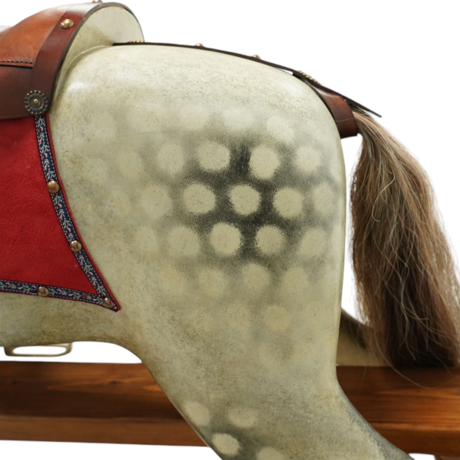 Frederick Henry Ayres (F H Ayres, London) - Late Victorian large carved wooden rocking horse, in dapple grey paint finish, decorated with glass eyes, leather reins, stirrup and saddle, indented hooves, on rockers united by chamfered stretchers and boarded base, c.1890